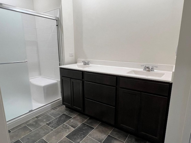 bathroom featuring vanity and a shower with door