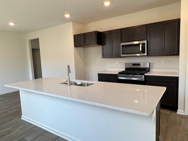 kitchen featuring dark hardwood / wood-style flooring, sink, an island with sink, and stainless steel appliances