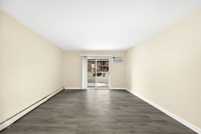 empty room with dark wood-type flooring, a wall unit AC, and a baseboard heating unit