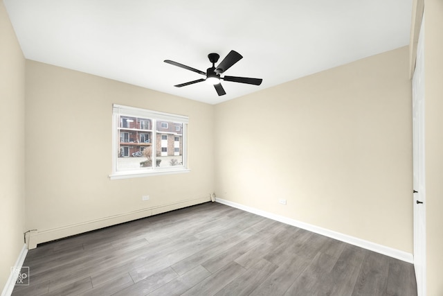 spare room with ceiling fan, light hardwood / wood-style floors, and a baseboard heating unit