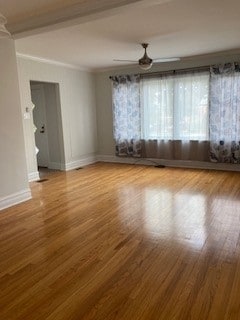 unfurnished room featuring hardwood / wood-style floors, ceiling fan, and crown molding