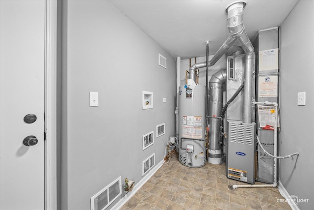 utility room featuring heating unit and water heater