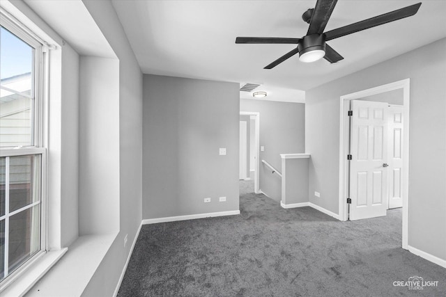 carpeted empty room featuring ceiling fan