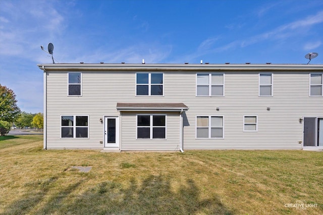 rear view of property featuring a yard