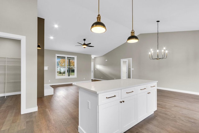 kitchen with white cabinetry, a center island, hardwood / wood-style floors, and decorative light fixtures