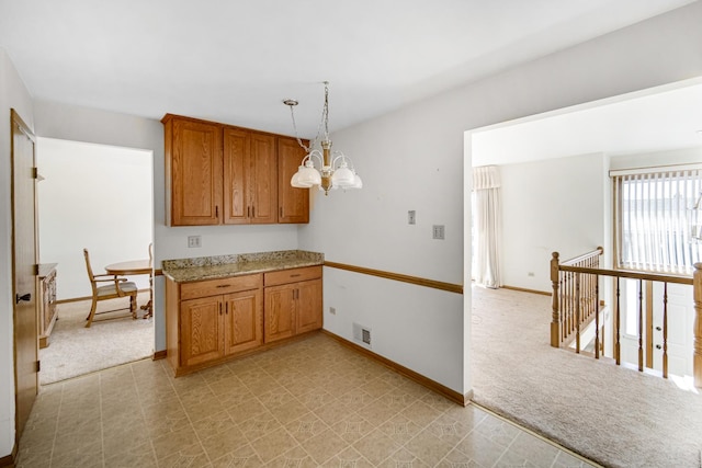 kitchen with light carpet, pendant lighting, and an inviting chandelier