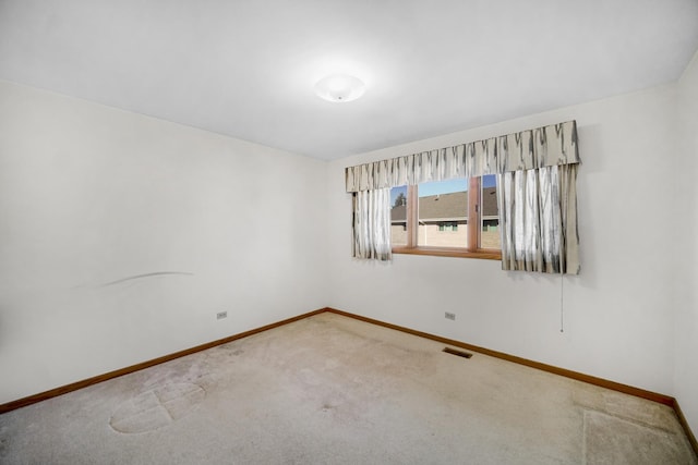 unfurnished room featuring carpet