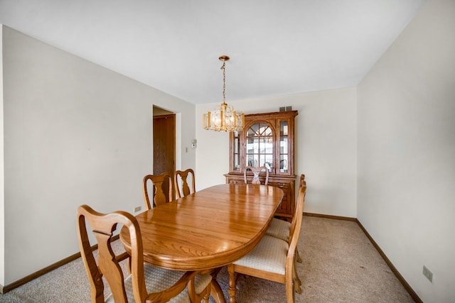 dining area with light carpet and an inviting chandelier