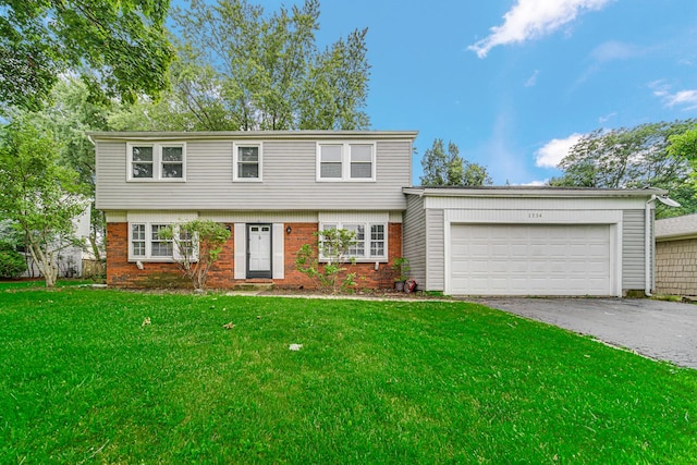 view of front property featuring a front yard and a garage