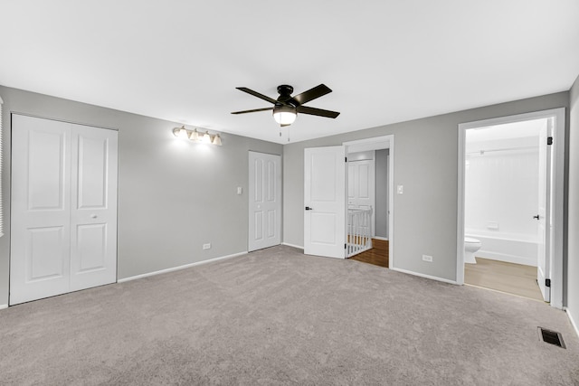 unfurnished bedroom with connected bathroom, ceiling fan, and light carpet