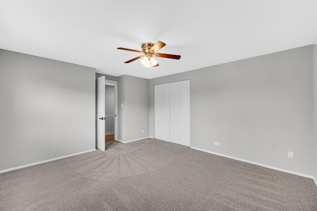 unfurnished bedroom featuring ceiling fan, light carpet, and a closet