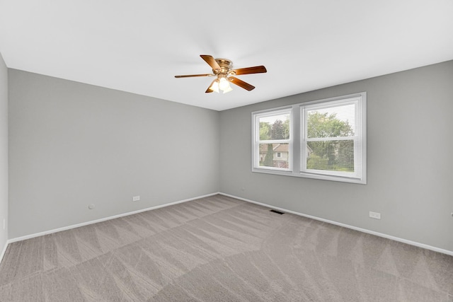 unfurnished room with ceiling fan and light colored carpet