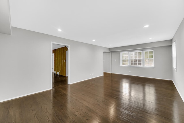 spare room with dark hardwood / wood-style flooring