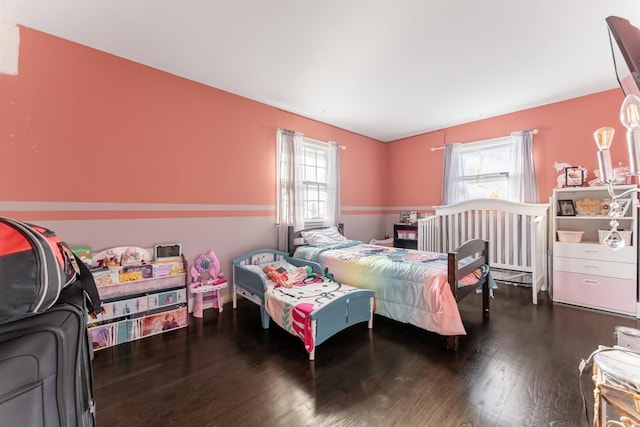 bedroom featuring multiple windows and wood-type flooring