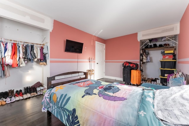 bedroom with dark hardwood / wood-style flooring and a closet