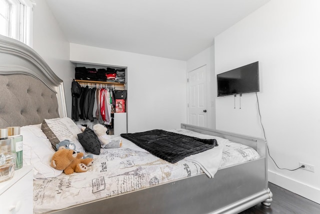 bedroom featuring dark hardwood / wood-style flooring and a closet