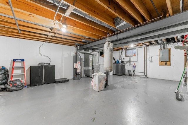 basement with electric panel, sink, heating unit, and gas water heater