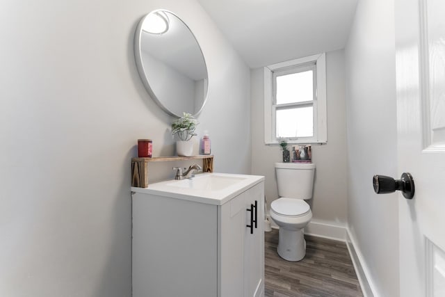 bathroom featuring hardwood / wood-style flooring, vanity, and toilet