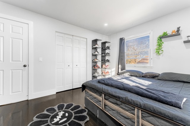 bedroom with a closet and dark wood-type flooring