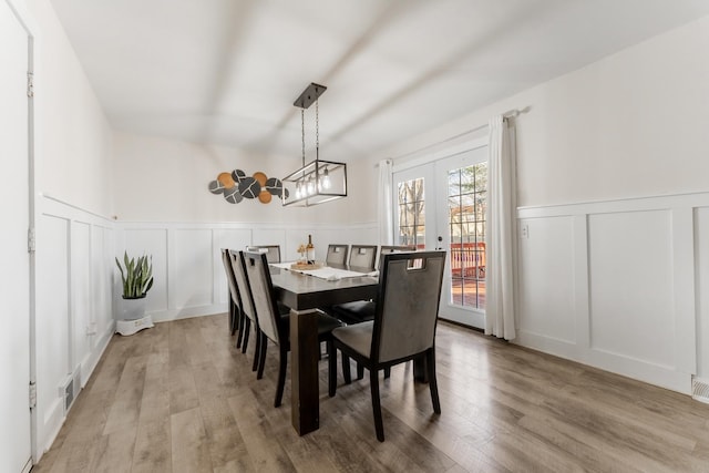 dining area featuring french doors and hardwood / wood-style floors