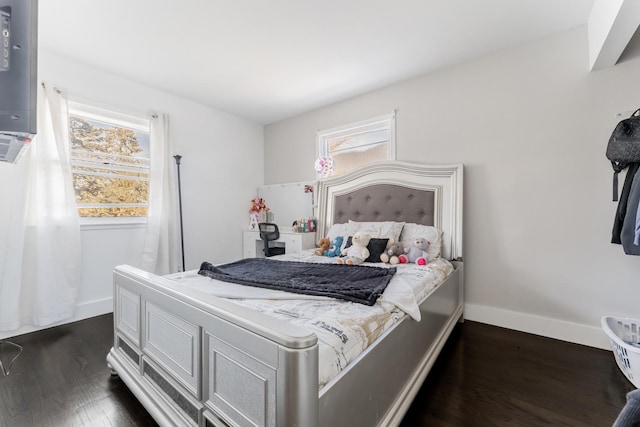 bedroom with dark hardwood / wood-style floors