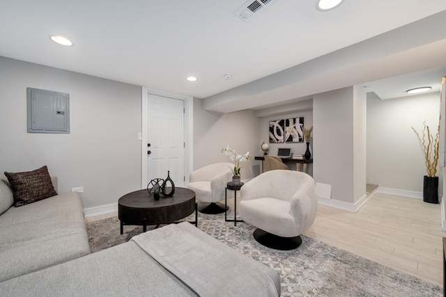 living room with electric panel and light hardwood / wood-style floors