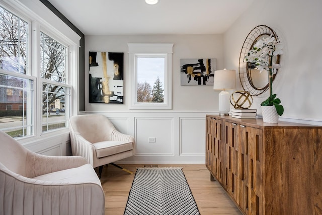 living area featuring a wealth of natural light and light hardwood / wood-style flooring