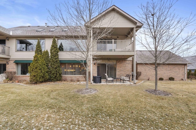 rear view of property with a patio area, a balcony, and a yard