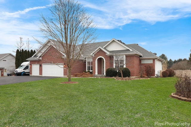 view of front of house featuring a front yard and a garage