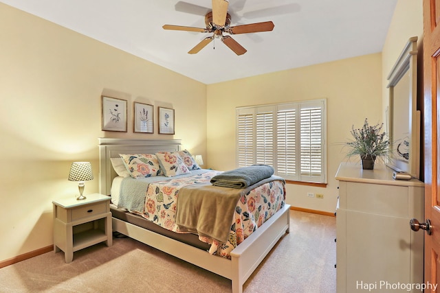 bedroom featuring ceiling fan and light carpet