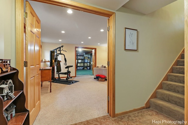 exercise room featuring light colored carpet