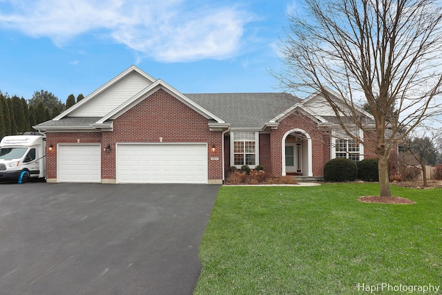 view of front of property featuring a garage and a front lawn