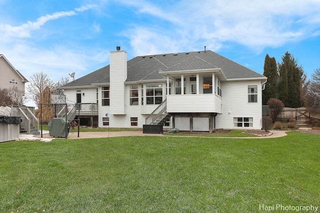 back of house with a sunroom, a deck, a yard, and central air condition unit