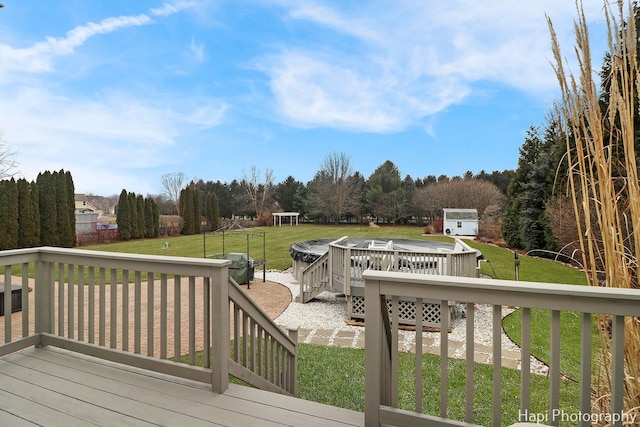 wooden deck with a patio area and a lawn