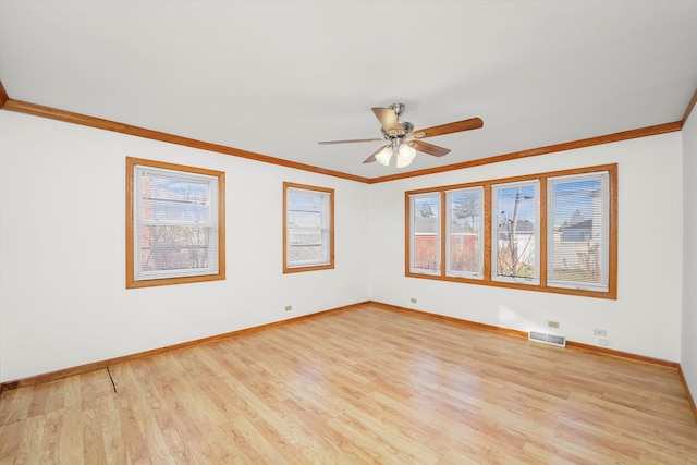 empty room featuring ceiling fan, ornamental molding, and light wood-type flooring