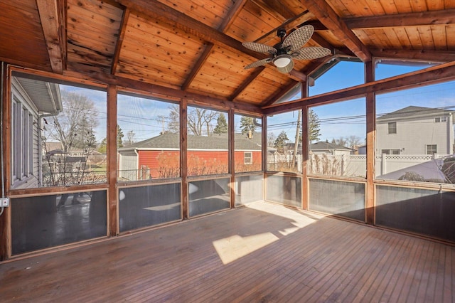 unfurnished sunroom featuring vaulted ceiling with beams, ceiling fan, and wood ceiling