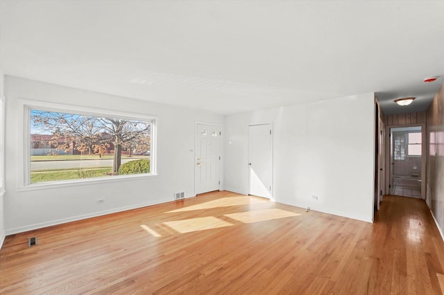 spare room with light hardwood / wood-style flooring