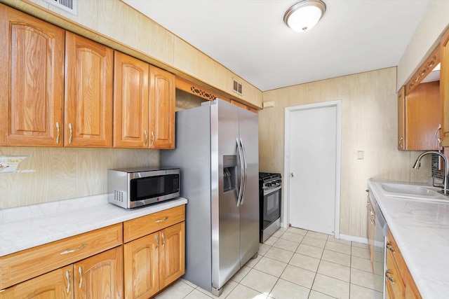 kitchen featuring sink, light tile patterned floors, and appliances with stainless steel finishes