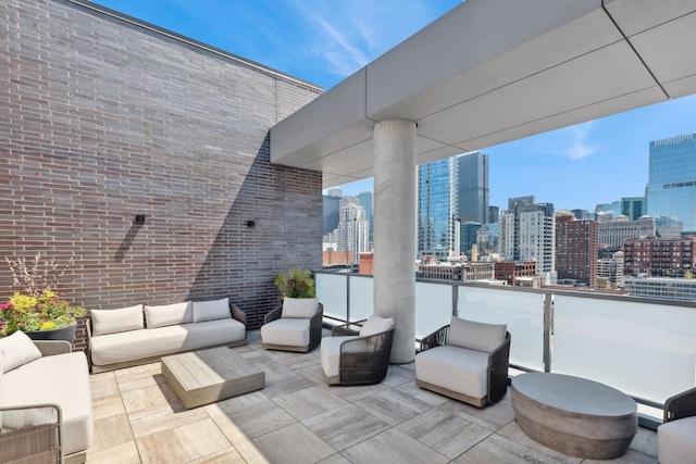 view of patio / terrace featuring baseboard heating, a balcony, and an outdoor hangout area