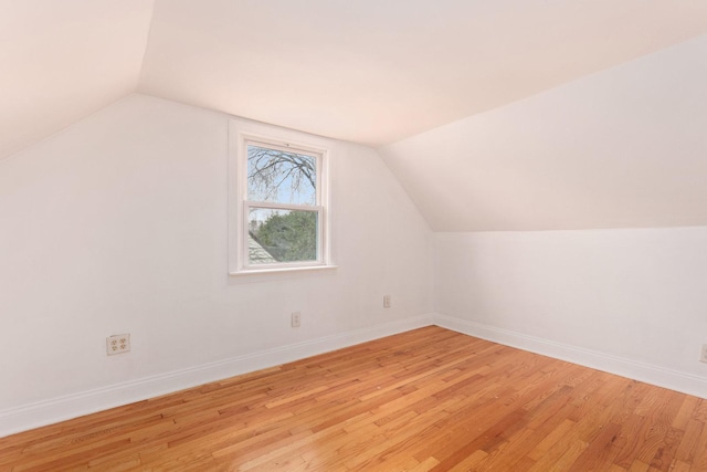 bonus room with light wood-type flooring and lofted ceiling