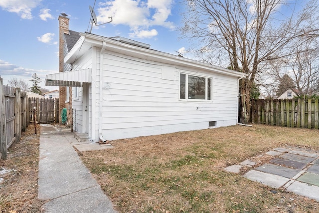 view of home's exterior with a yard