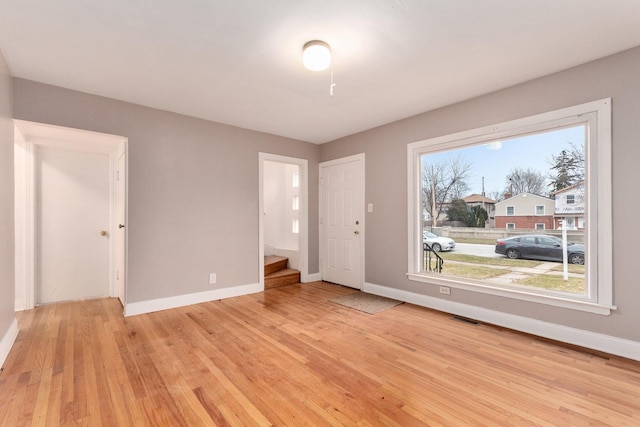 unfurnished bedroom featuring light wood-type flooring and a closet