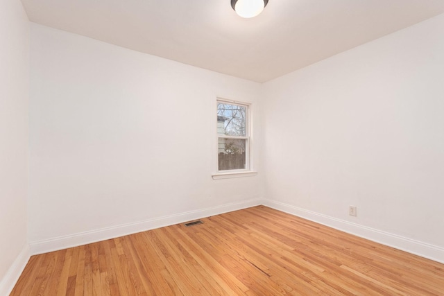 empty room with hardwood / wood-style flooring