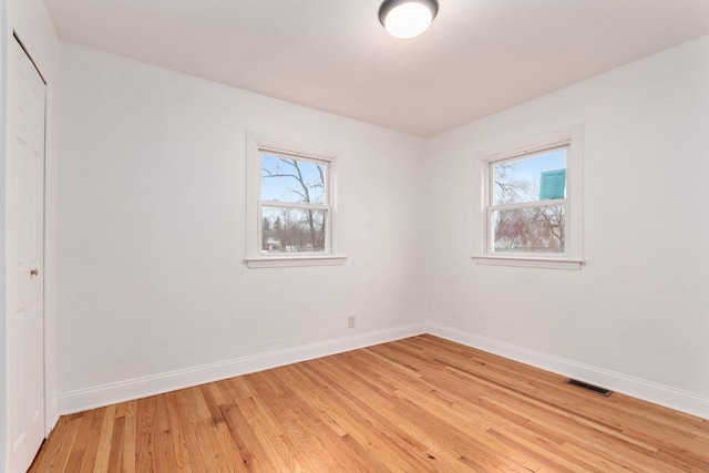 empty room with light hardwood / wood-style floors