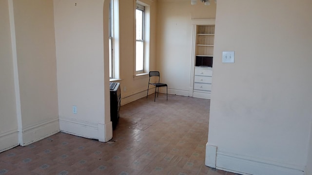 spare room with hardwood / wood-style floors and a healthy amount of sunlight