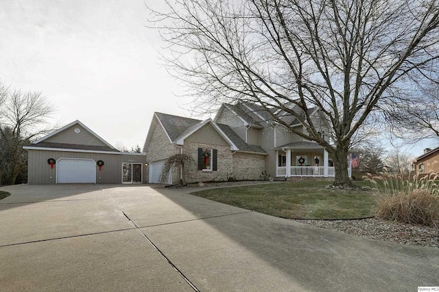 view of front of home with a garage, covered porch, and a front lawn