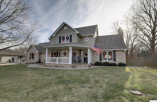 view of front of house with a front yard and a porch