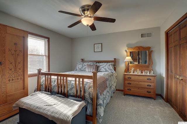 bedroom with light colored carpet, a closet, and ceiling fan