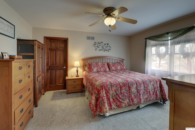 bedroom featuring ceiling fan and light carpet