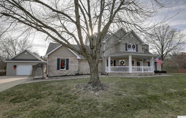 view of front facade featuring a porch, a garage, and a front lawn